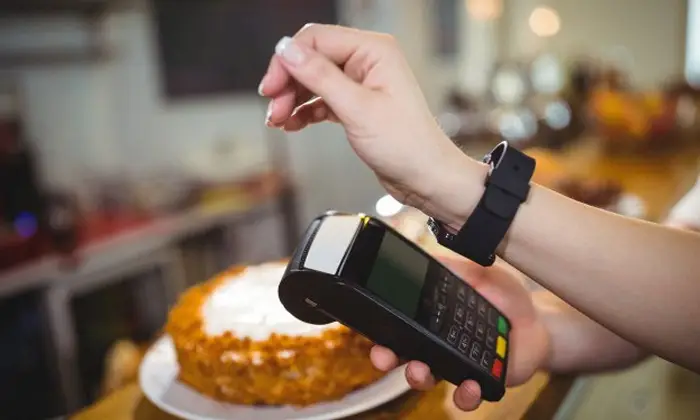 woman using smart watch for payment