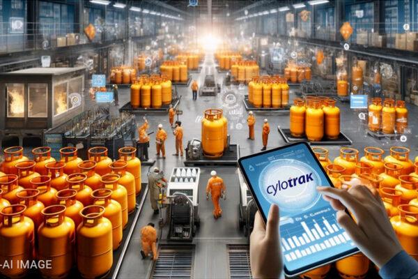 A person holding a tablet in front of a factory
