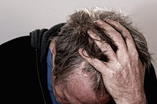 A man with his hand on his heads