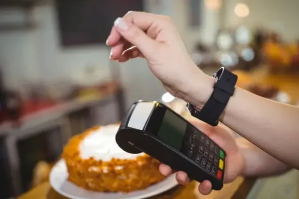 woman using smart watch for payment